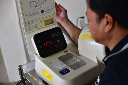 Patient measuring blood pressure in the hospital.の写真素材
