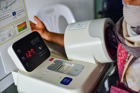 Patient measuring blood pressure in the hospital.の写真素材