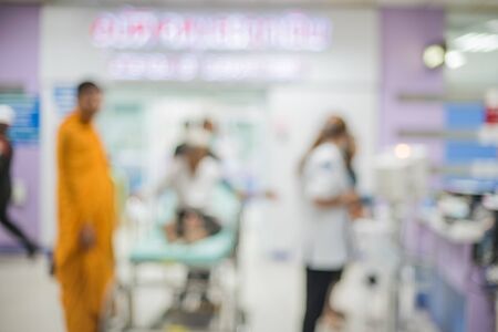 Blurred hospital background with patient on bed showing quality of healthcare service for treatment.の写真素材