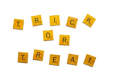 Trick or treat, Happy Halloween word on wooden texture isolated on white backgroundの写真素材