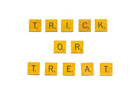 Trick or treat, Happy Halloween word on wooden texture isolated on whiteの写真素材