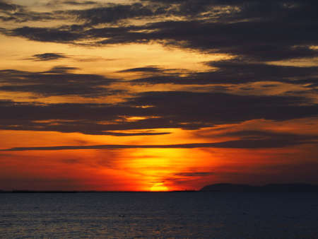Dramatic sunset like fire at the beachの写真素材