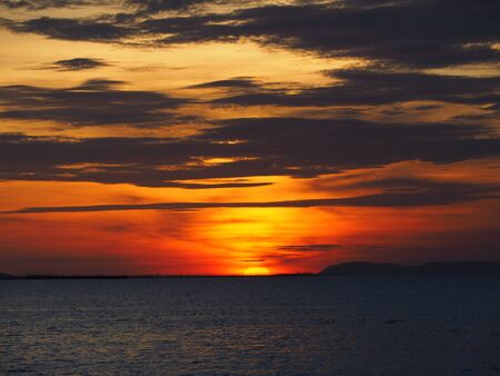 Dramatic sunset like fire at the beachの写真素材