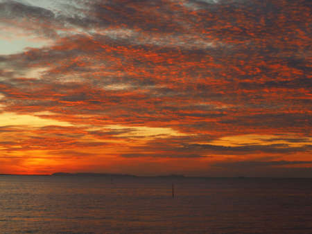 Dramatic sunset like fire at the beachの写真素材