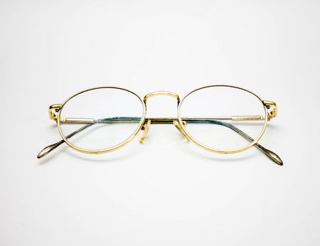 golden frame glasses on white background.の写真素材
