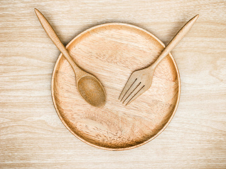 Wooden cutlery on wooden background. Top viewの写真素材