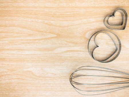 Utensil Kitchen stainless and whisk for cooking on wooden background. Top view white copy space.の写真素材