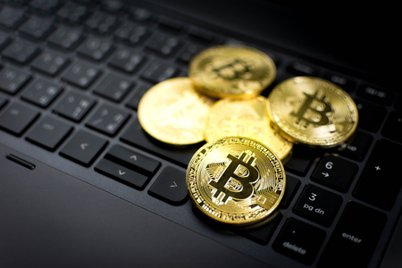 Golden Bitcoins on computer keyboard background.の写真素材