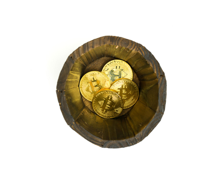 Golden Bitcoins in barrel. Digital symbol of a new virtual currency on isolate background.の写真素材