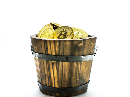 Bitcoin Mining, Golden bitcoins in hand. Digital symbol of a new virtual currency on isolate background.の写真素材