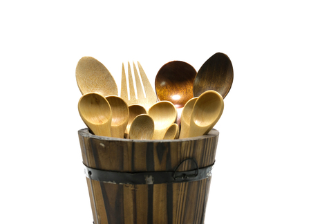 Wooden spoon and fork in barrel on isolate background.の写真素材
