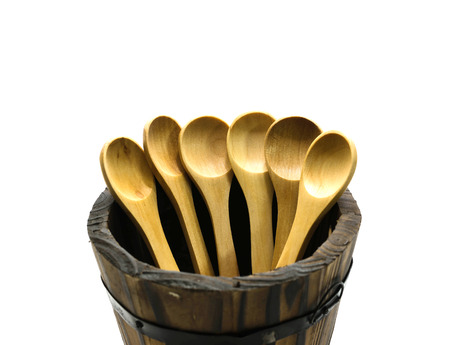 Wooden spoon in barrel on isolate background.の写真素材