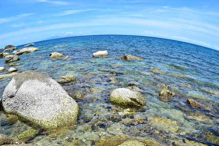 The stone on the beach with blue sea at Koh Chang island in Thailand, with fisheye lensの写真素材