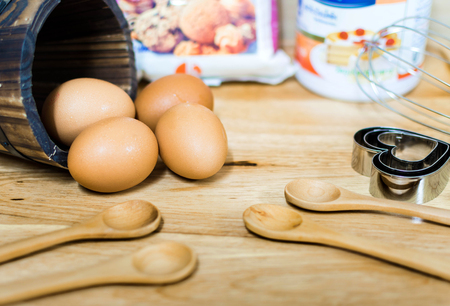 flour with egg and ingredients for homemade bakery on wooden backgroundの写真素材