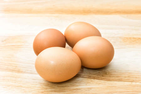 fresh eggs on wooden backgroundの写真素材