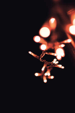 Abstract Shot Of Red Pink Hanging Christmas Lights During Nightの写真素材