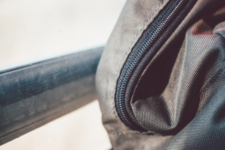 Close-Up Of Olive Green Backpack With Black Zipper Resting On Train Window While Traveling