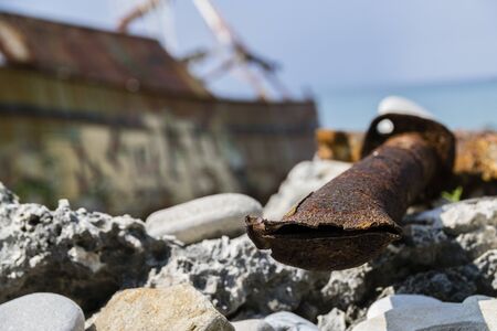 Close-Up Of Severed Rusty Pipe Washed-Up On Greek Beachの写真素材