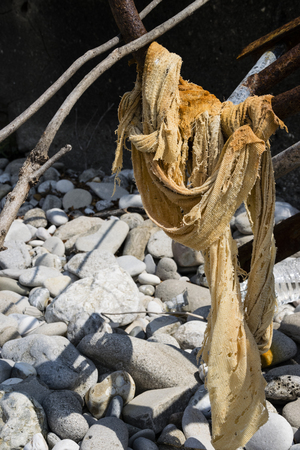 Side Angle View Of Washed-Up Woven Fabric On Greek Beachの写真素材
