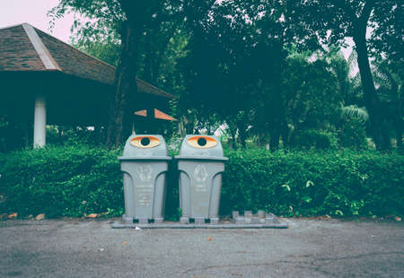 There were 3 plastic recycling bins in the Rama 9 public park laid on an asphalt road, but one was missing.の写真素材