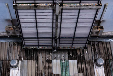 Old exhaust hood on an old roof, a covered fire exit.の写真素材