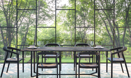 Modern dining room with garden view 3d rendering Image.There are large window overlooking the surrounding garden and nature and finished with black furnitureの写真素材
