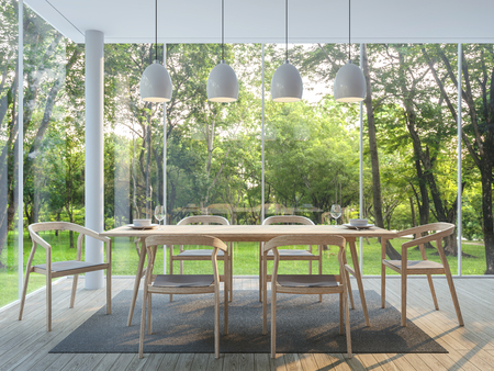 Modern dining room in the glass house 3d render image There are wooden floor there are large window overlooking to the garden and nature and finished with wood furnitureの写真素材