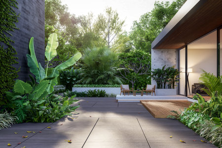 Modern loft style tropical garden of modern house 3d render illustration. There are stone floor decorate with concrete wall and rainforest treeの写真素材