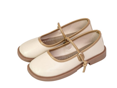 Cream shoes with brown trim and strap featuring classic round toe and sturdy sole isolated on white background. Ideal for childrenâs fashion, footwear, and elegant style themes.の写真素材