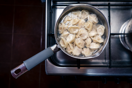 Dumplings are cooked in a saucepan.の写真素材