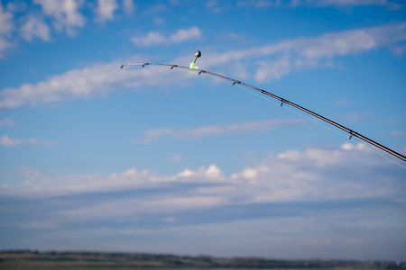 The abandoned feeder rod in a summer day on the river Northern Dvinaの写真素材