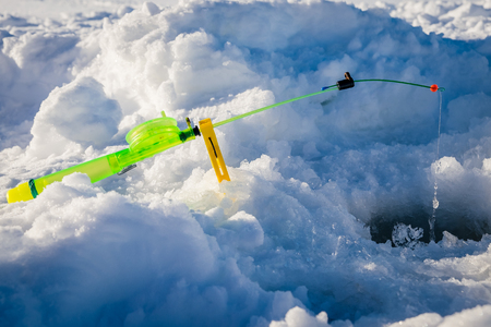 Fishing rod for winter fishing, lelit at the hole in the snowの写真素材