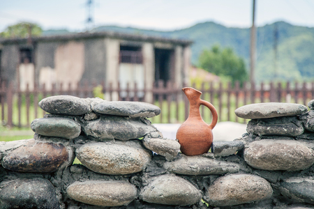 Clay pitcher on a fenceの写真素材