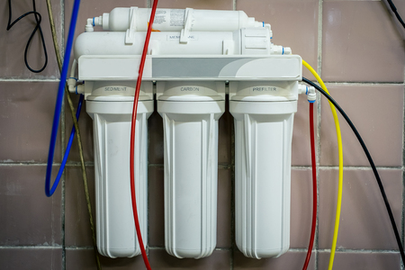industrial water filter hanging on the wall close-upの写真素材