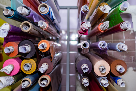 Colored vinyl rolls on the shelvesの写真素材