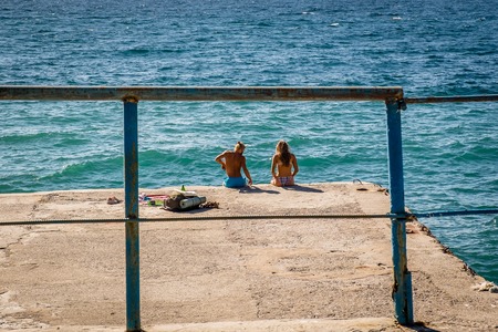 a young man and a girl on the dockの写真素材