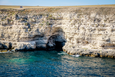 arch in the rock on the black seaの写真素材