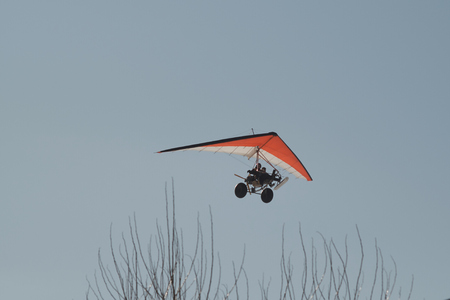 hang-glider flying in a sunny winter day