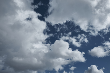 clouds against a blue sky on a spring sunny dayの写真素材