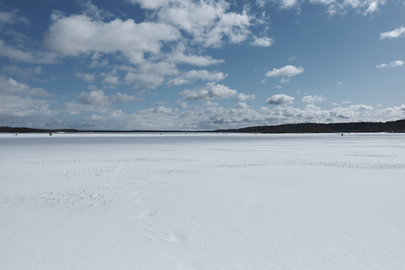 lake in winter, clouds in the sky, forestの写真素材