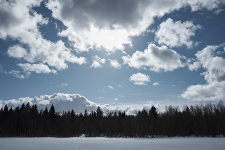 Lake in winter, clouds in the sky, forest, photo