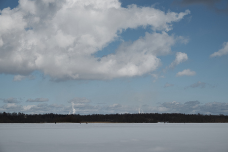 lake in winter, clouds in the sky, forestの写真素材