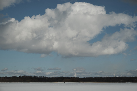 lake in winter, clouds in the sky, forestの写真素材