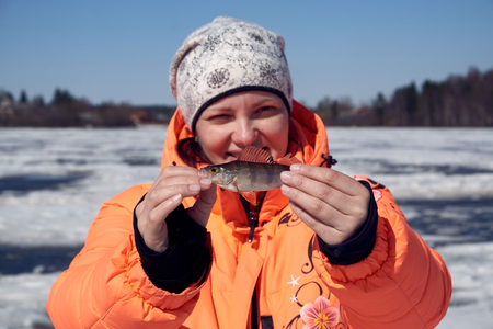 a girl with a perch on fishingの写真素材