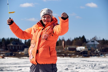 a girl with a perch on fishingの写真素材