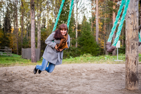 girl swinging on an old swingの写真素材