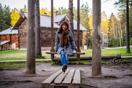 girl swinging on an old swingの写真素材