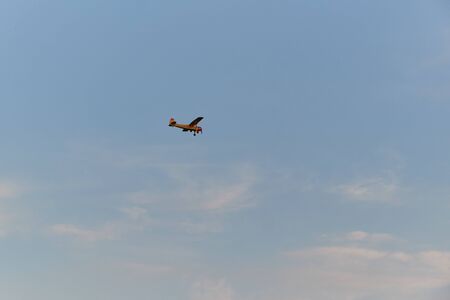 A small plane flies in the sky.
