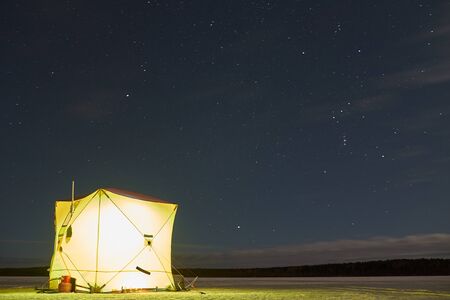 Winter fishing tent at night.の写真素材