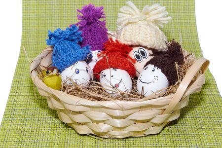 Easter eggs lie in a basket on a green cloth.の写真素材